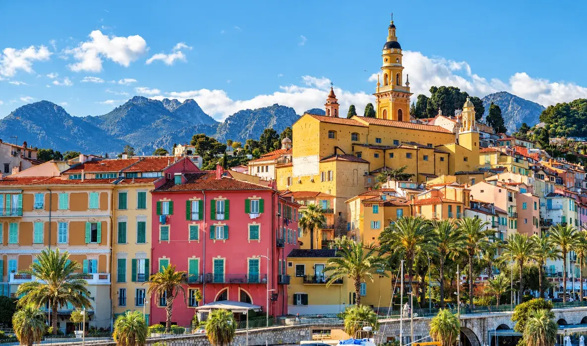 A colorful harbor town, black and white on one side and in color on the other