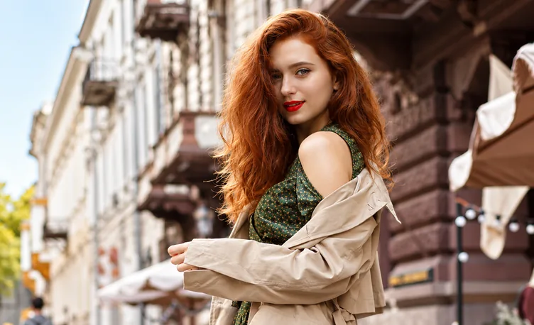 A portrait of a red-haired woman, low-resolution on the left and sharp on the right